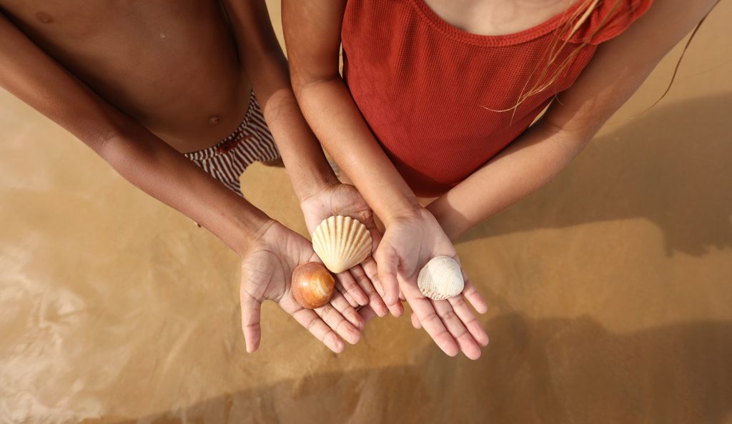 girls showing shells at vilamoura beach - real estate header image