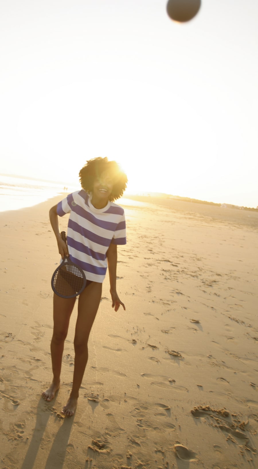 young woman playing rackets on the beach in vilamoura