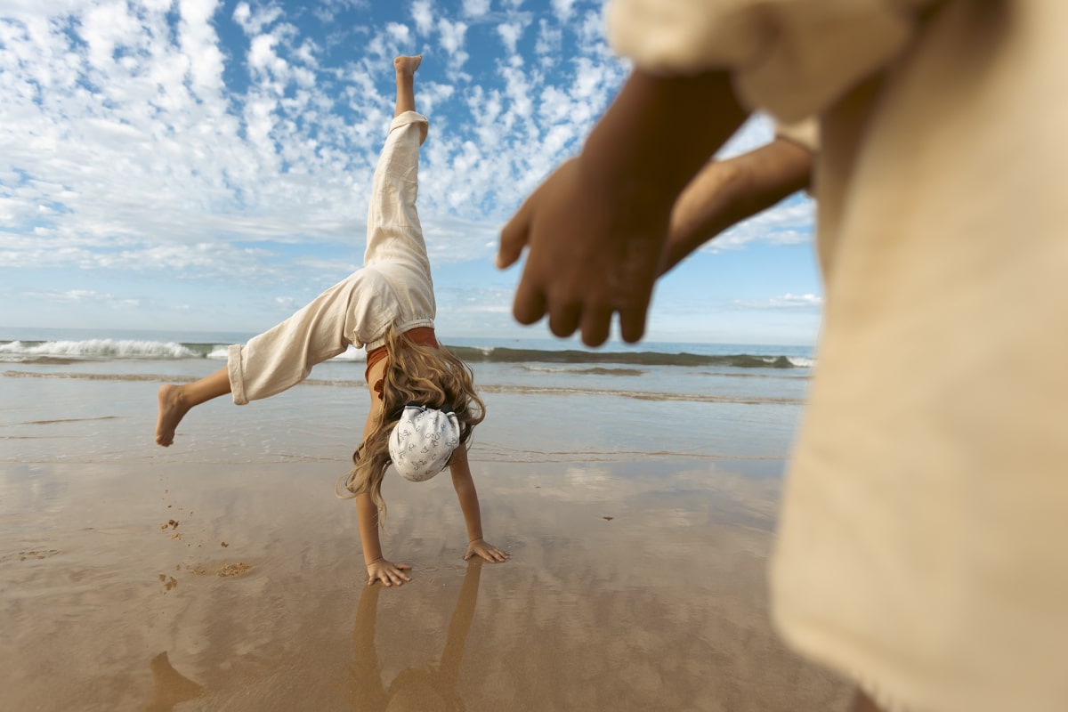 Girl doing a cartwheel on the beach