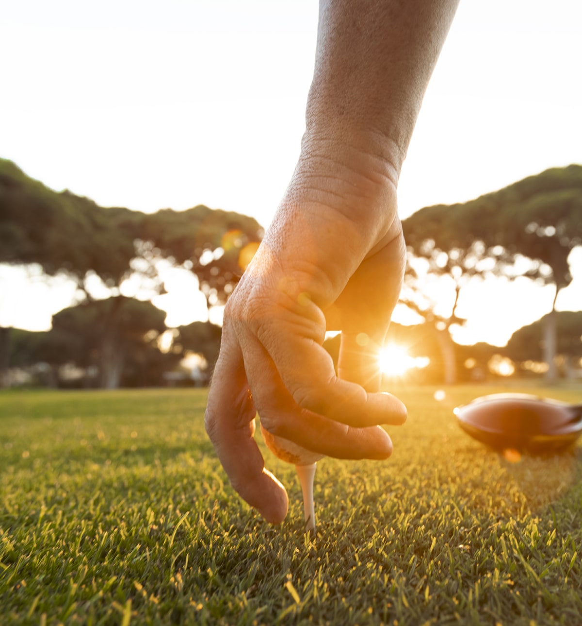 hand placing golf ball in vilamoura golf course