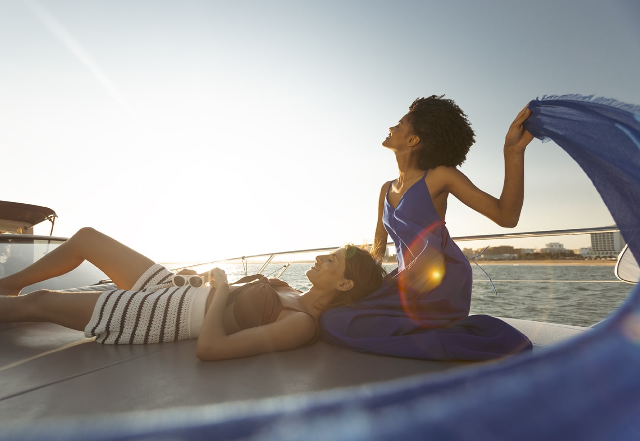 women friends relaxing on boat at vilamoura marina