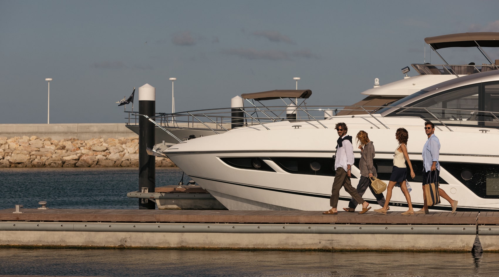 group of friends walking at vilamoura marina
